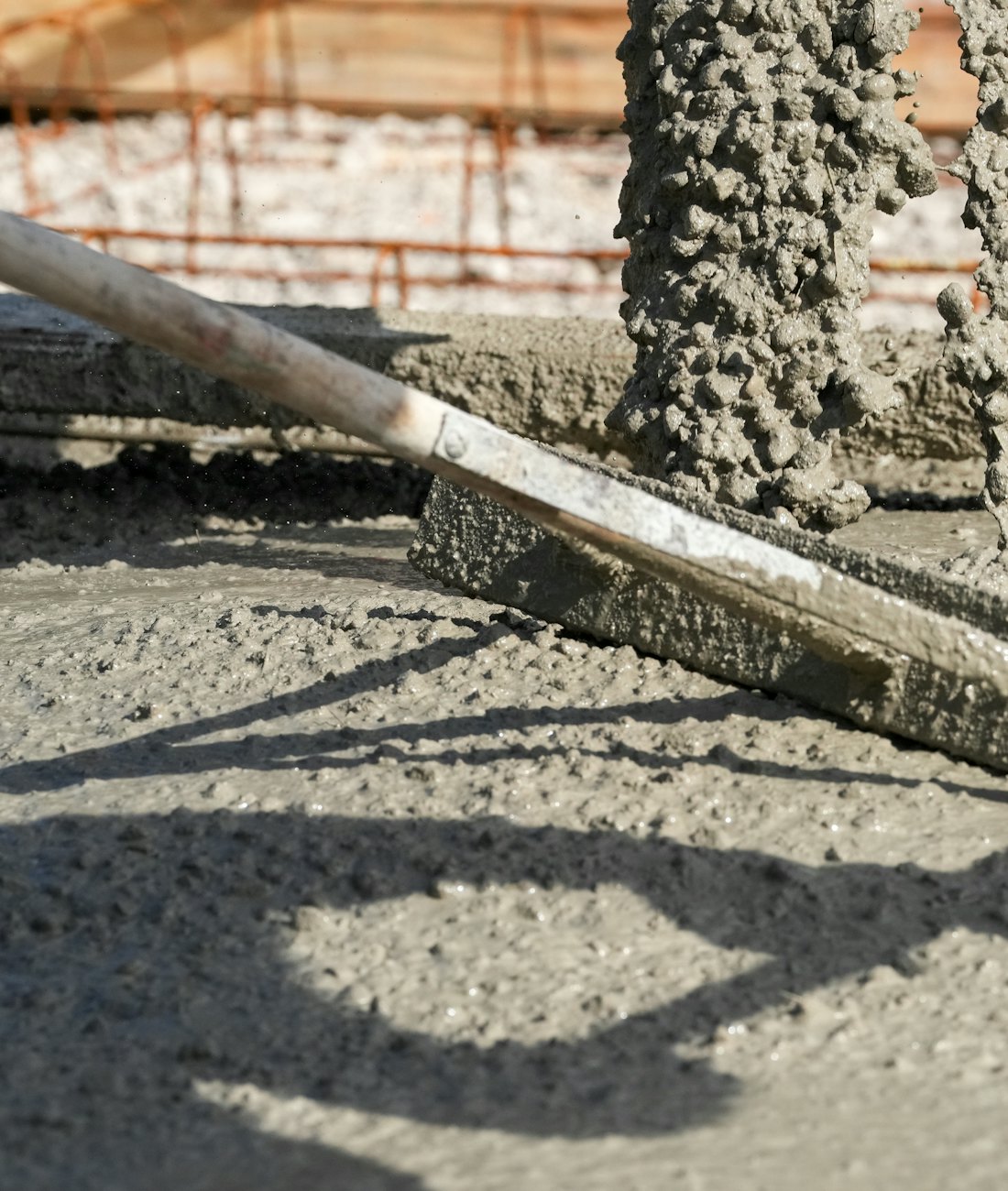 Close-up of concrete being screeded during placement